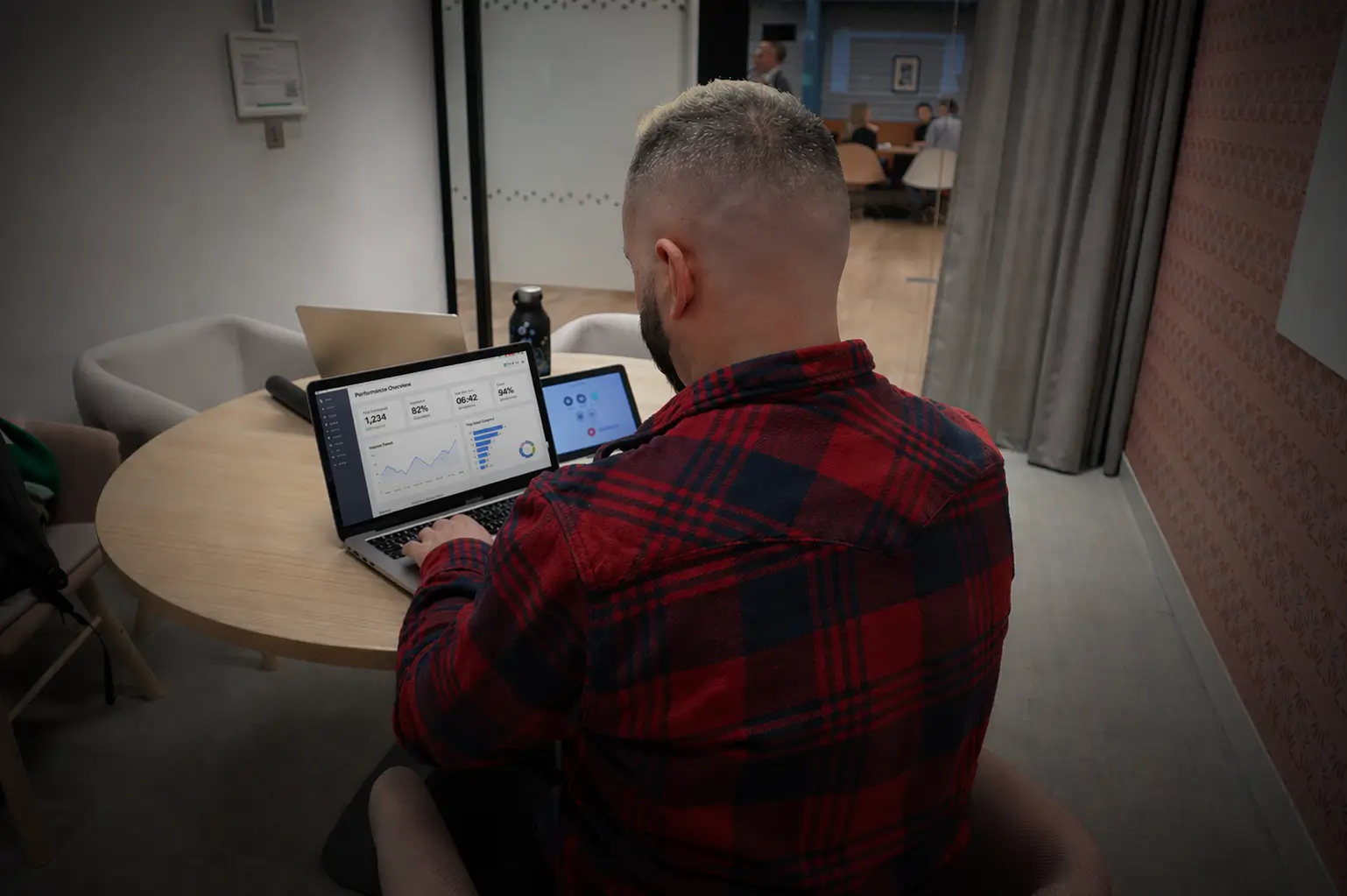 Team manager reviewing performance data on a laptop
