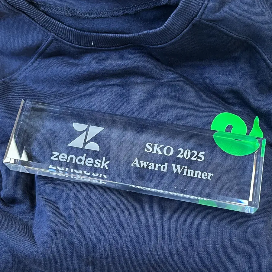 A glass award reading “Zendesk SKO 2025 Award Winner” next to the Geckoboard logo
